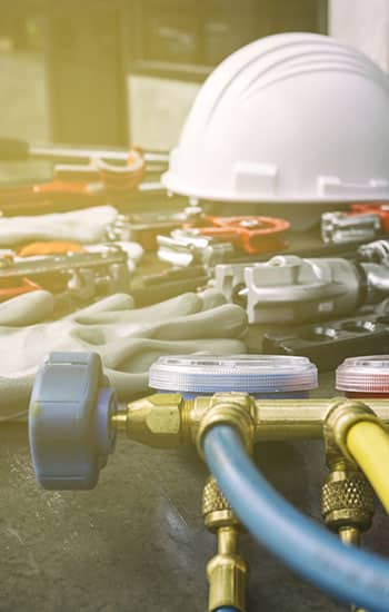 Tool for air conditioner maintenance Hard hat and tools used for HVAC preventative maintenance.